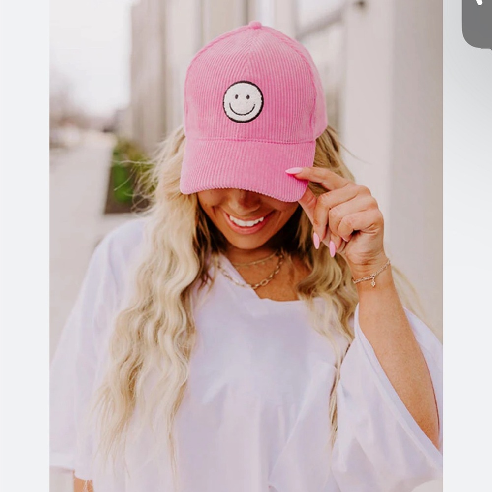 NWT pink corduroy hat with fuzzy smiley face